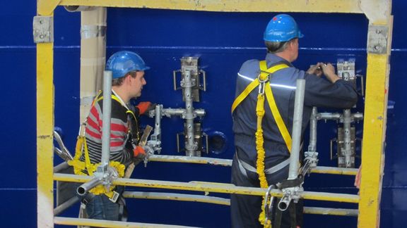 Two McNetiq employees place the magnetic scaffold anchors