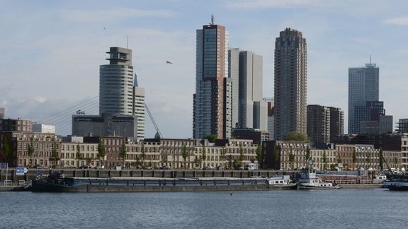 Skyline Rotterdam with barges at the quay