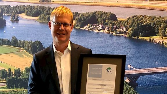 Eric van der Schans, head of environmental management at the Port of Rotterdam, shows the extended PERS certification.