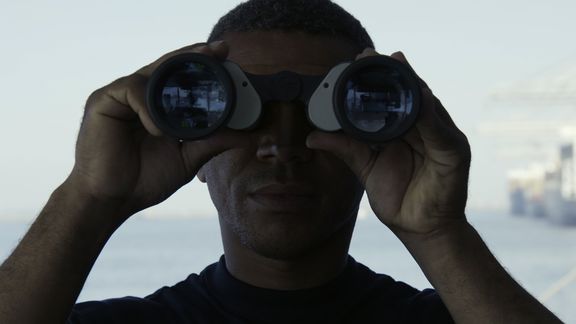 Man looking through binoculars