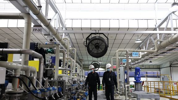 Two employees at the TES factory for recycling lithium-ion batteries