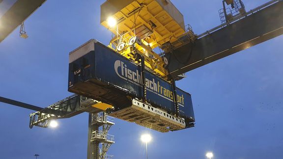 Container hanging from a crane