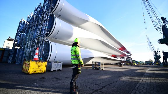 Port worker at blades offshore wind turbines