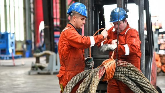 Employees secure cables at Franklin Offshore