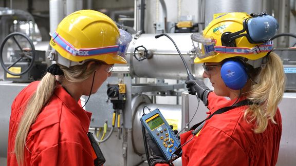 Two employees test an installation at Shell