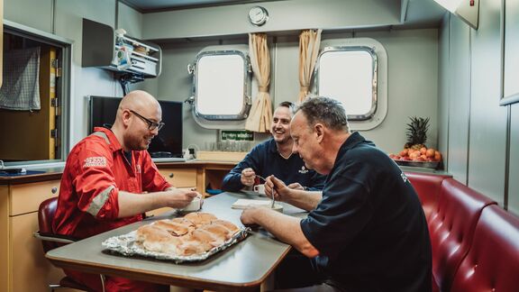 Crew eat lunch on board