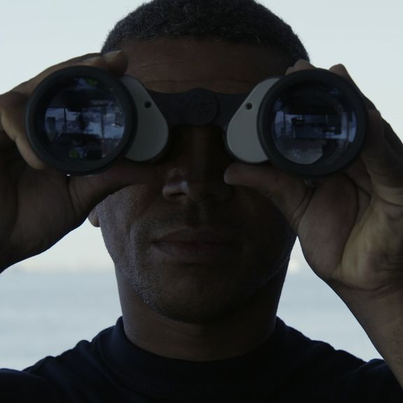 Man looking through binoculars