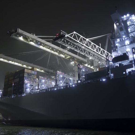 Container ship being loaded in the night