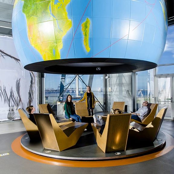 Visitors looking at the globe in FutureLand