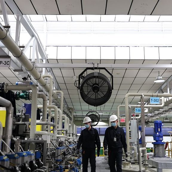 Two employees at the TES factory for recycling lithium-ion batteries