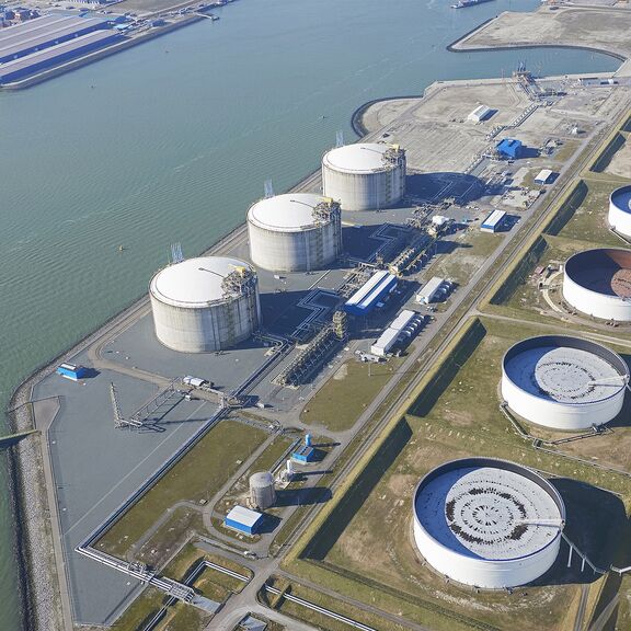 The 3 grey LNG tanks are located next to the water side - 4th LNG tank will be constructed next to these tanks.