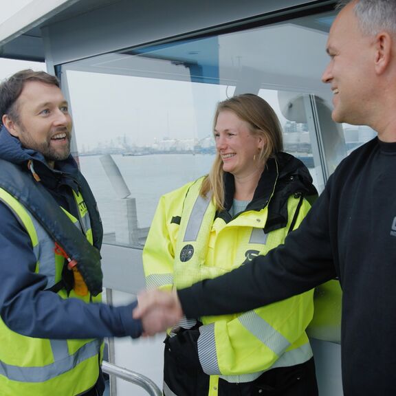 People shaking hands on an inland barge